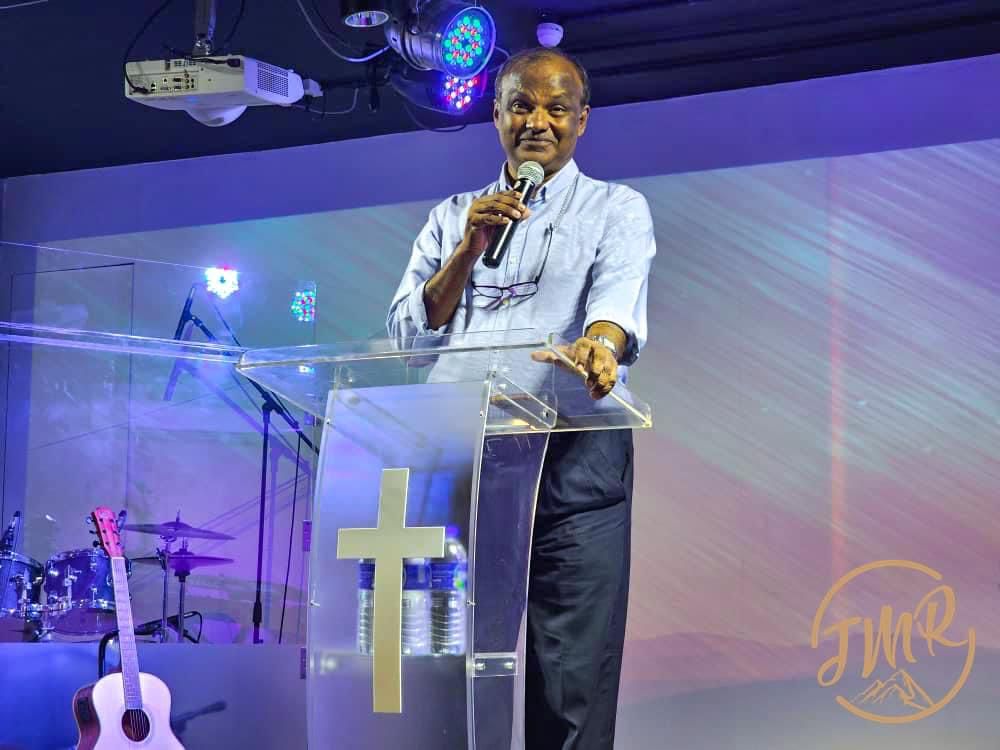 Jesus My Rock Church - Rev Edwin is on stage sharing about ICM
