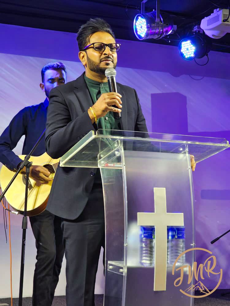 Pastor Derwin is sharing on stage at Jesus My Rock Church