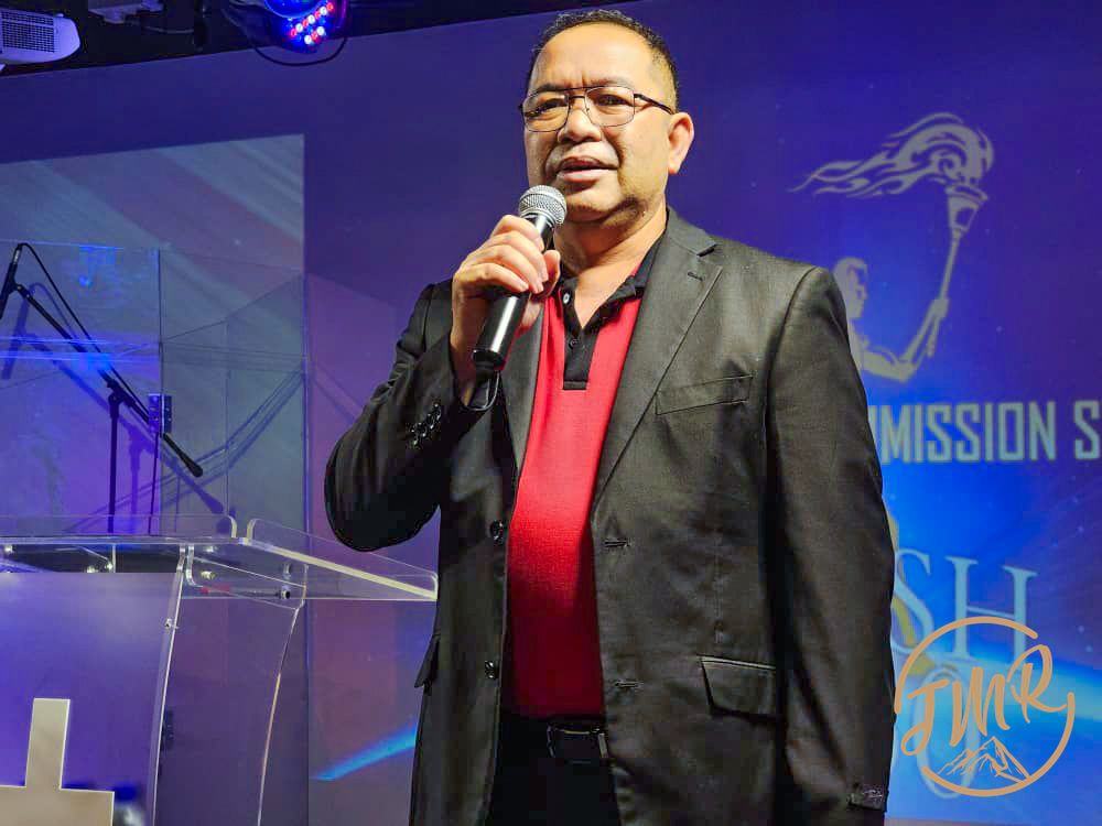 Rev Romed is sharing on stage at Jesus My Rock Church