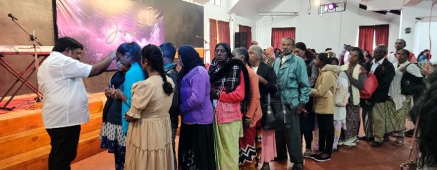 Ps Suhin is giving a prayer blessing to the congregation at Hossanna Garden Church