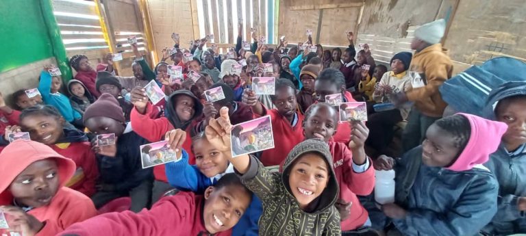 Joyful, children showing off their picture of Jesus Christ