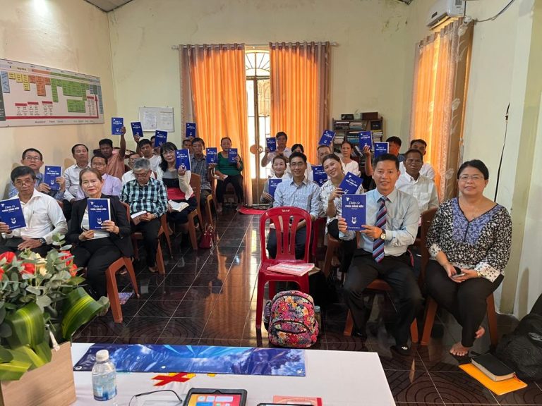 All attendees showing the handbook in ICM Conference
